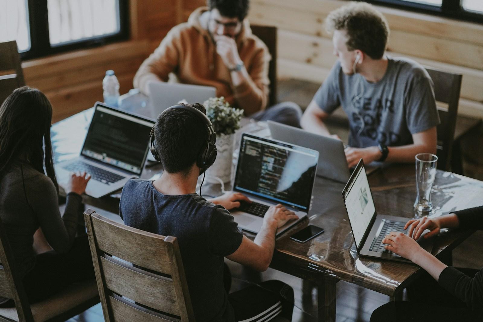 People working on laptops in a shared workspace