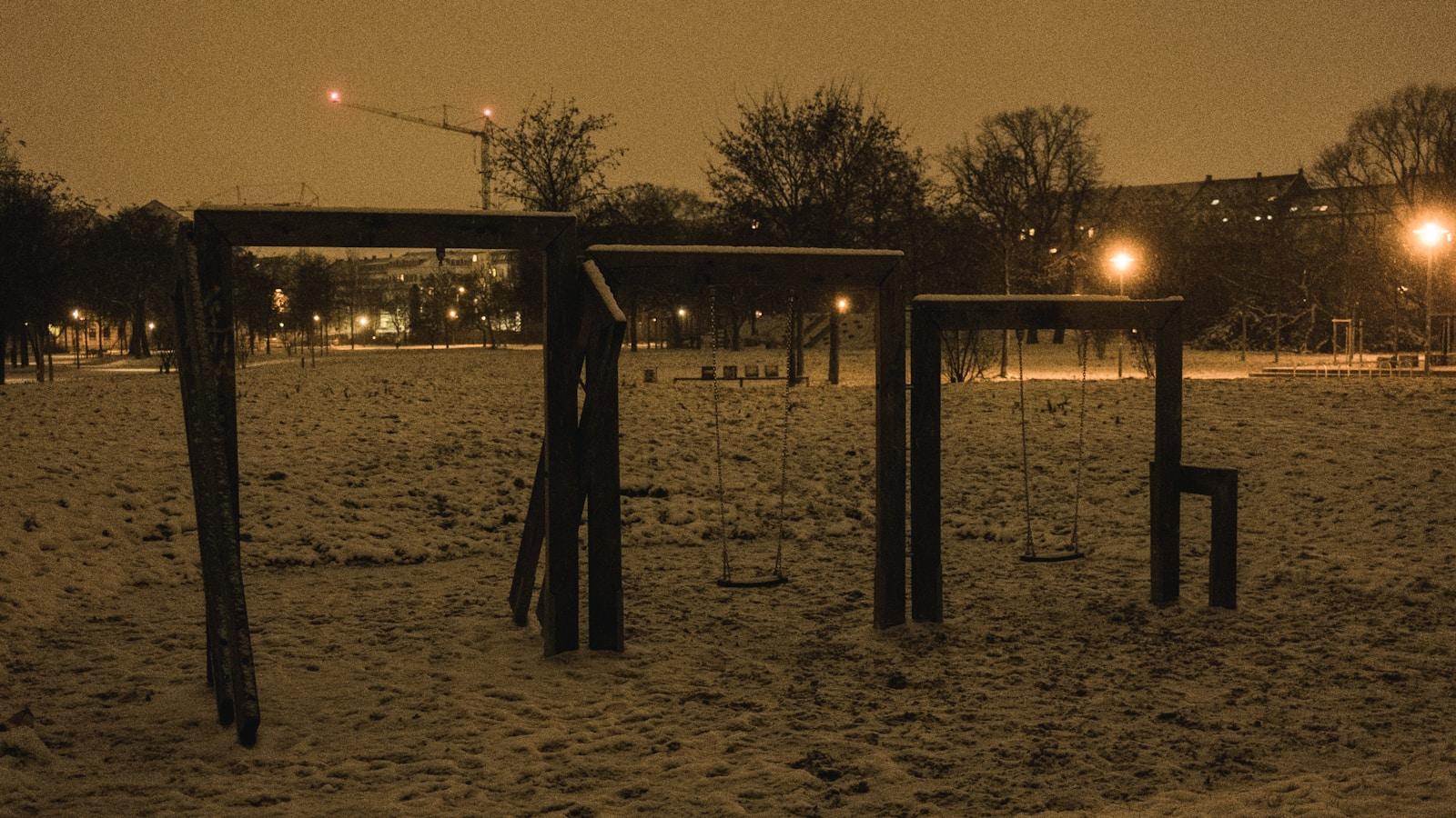 Empty playground swings at night