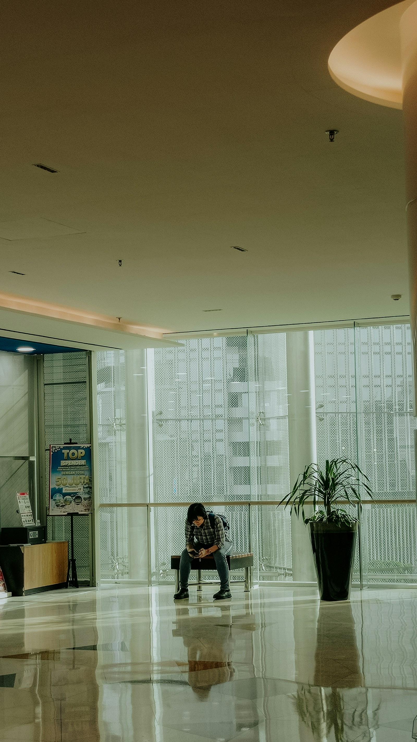 Person sitting alone looking at a phone