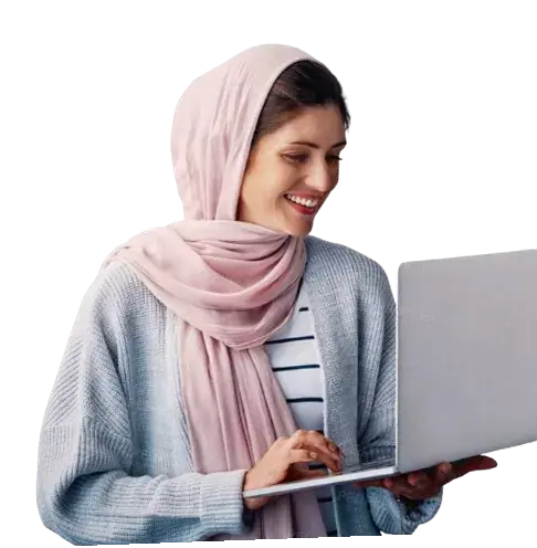 Smiling woman in a headscarf working on a laptop