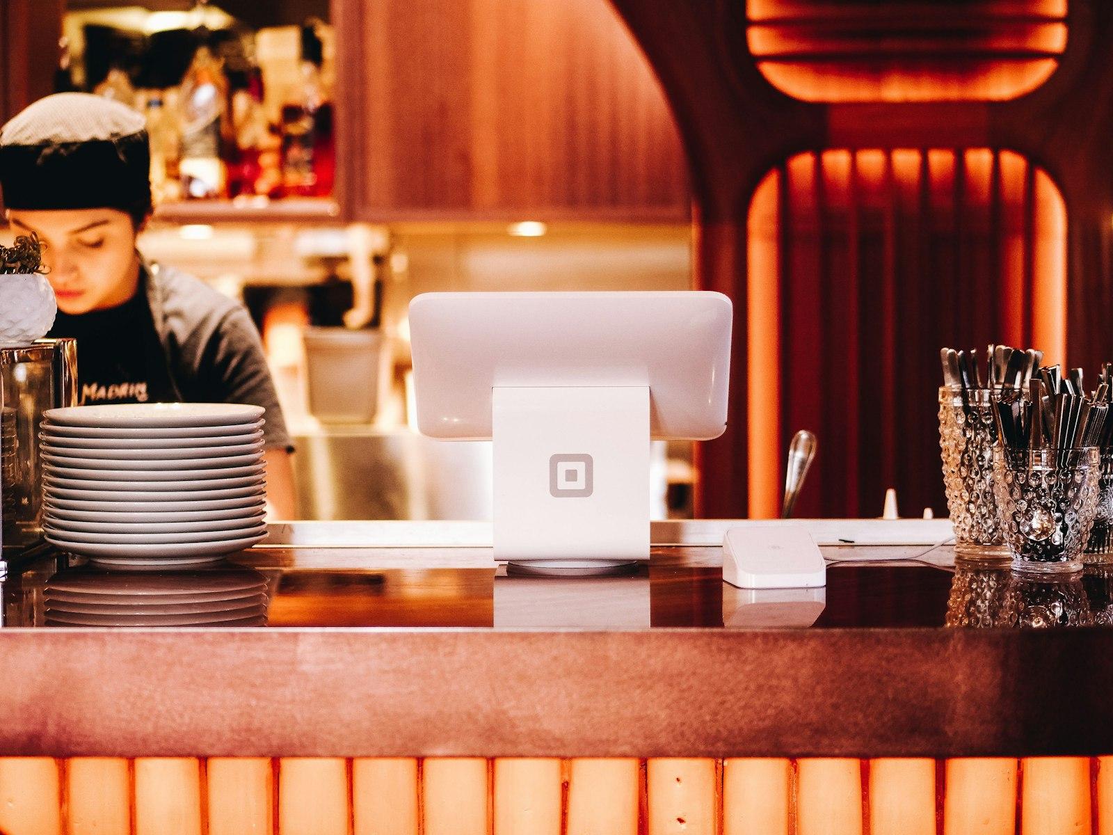 A barista working behind the counter of a warm café